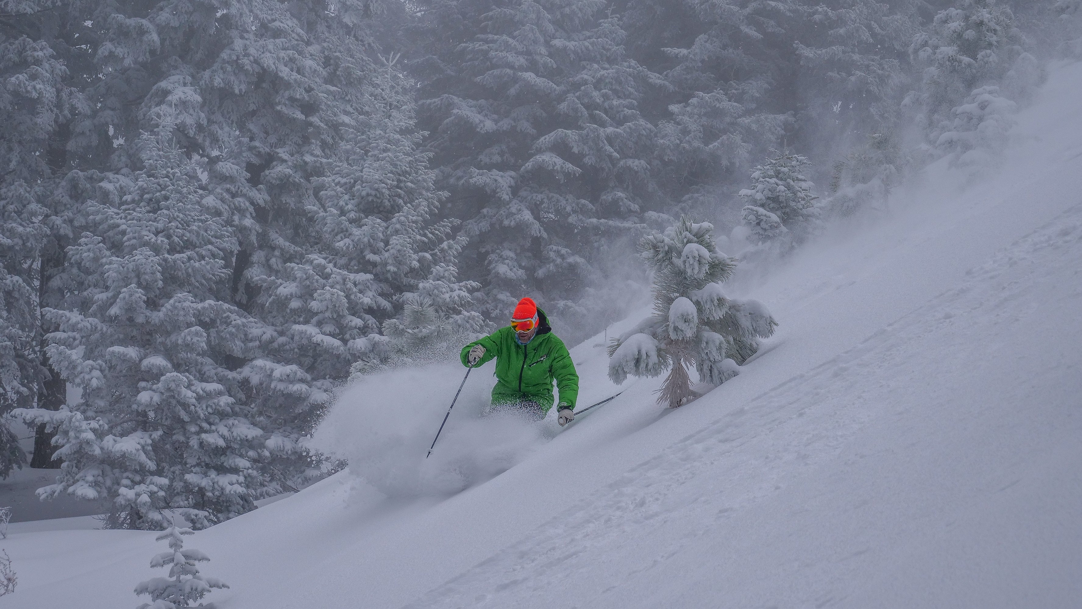 Skiing through powder on a powder day at Mountain High Resort