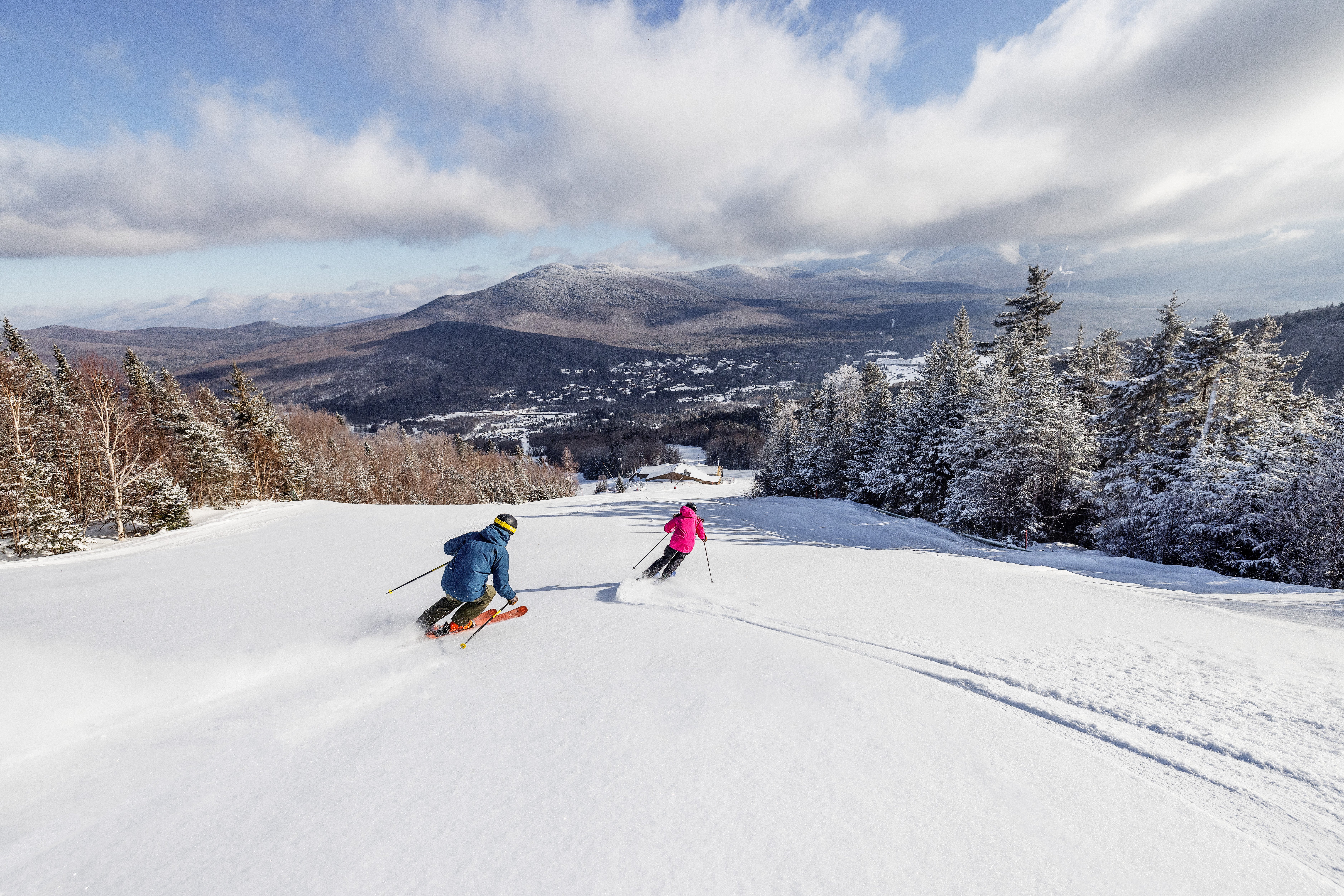 Skiers going down groomed ski run at Deer Valley