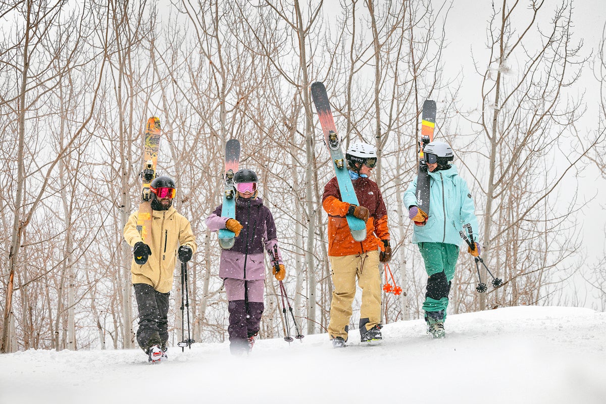 Group of skiers walking in snow while it's snowing