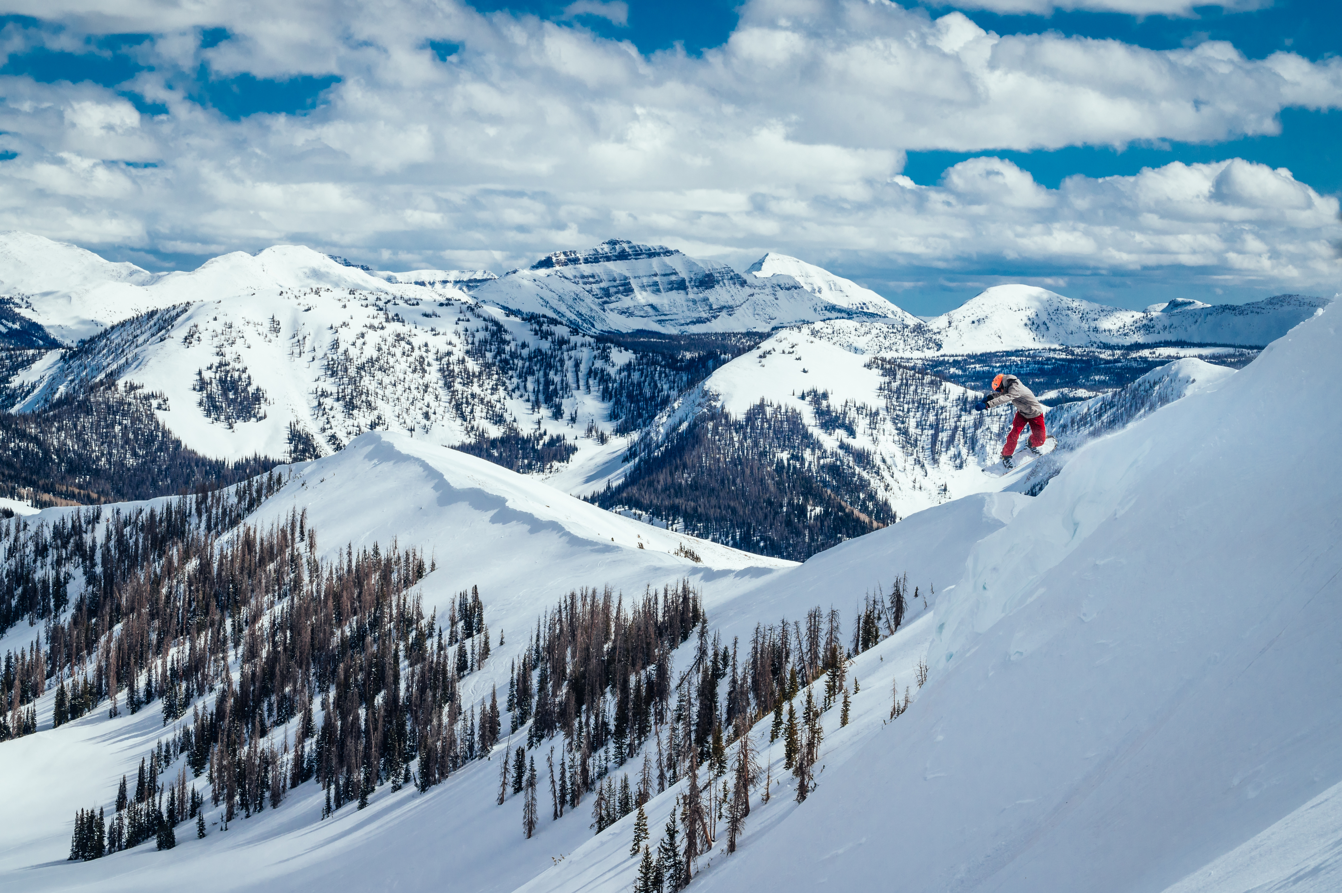 Snowboarder catching air at Park City Mountain Resort on a powder day