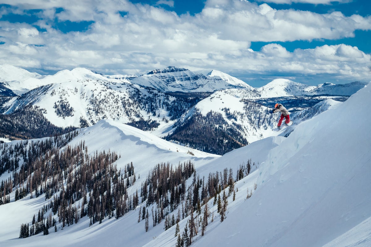 Snowboarder catching air at Park City Mountain Resort on a powder day