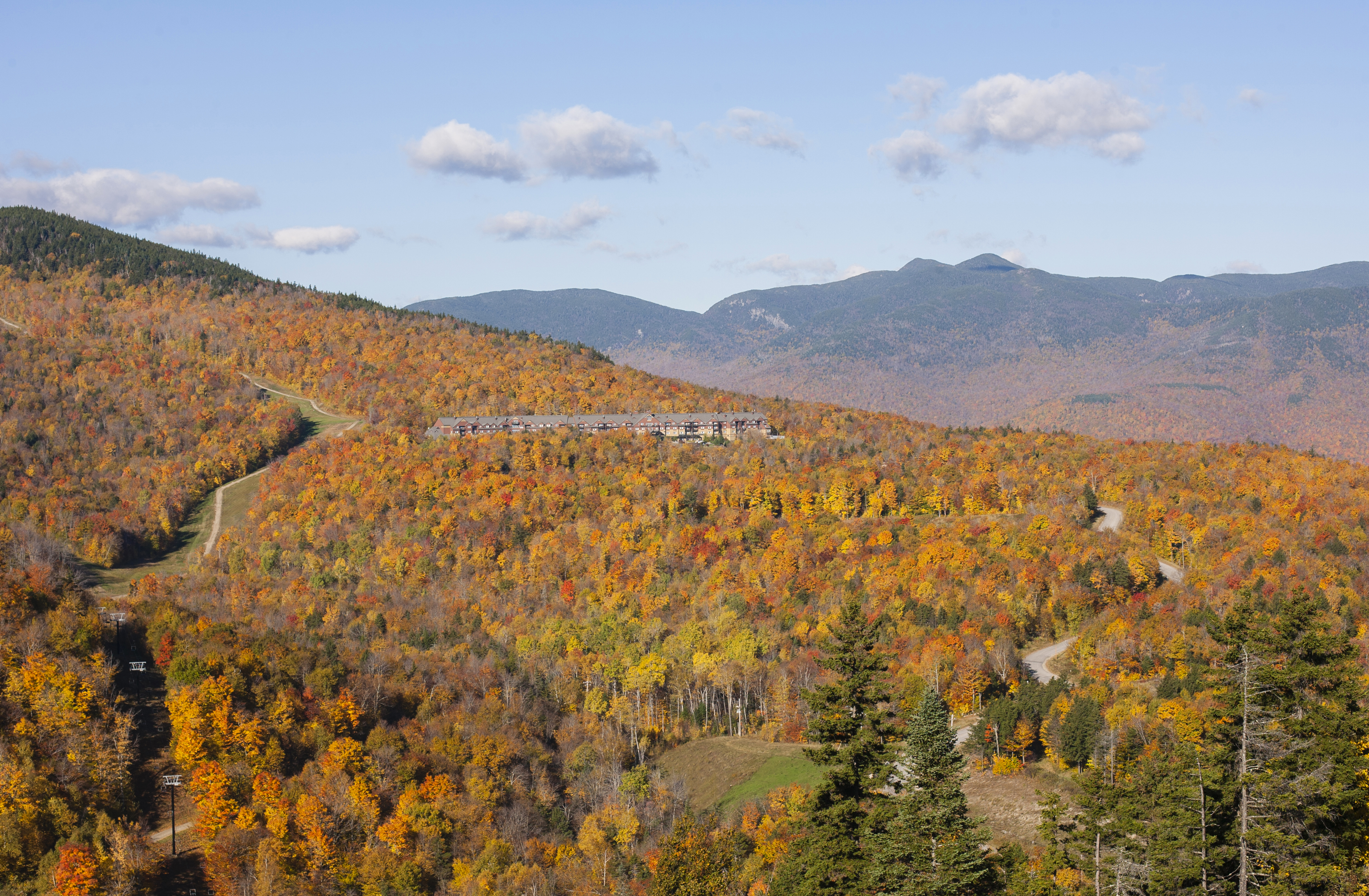 View of Sunday River's chairlifts and the valley below from atop the ski area