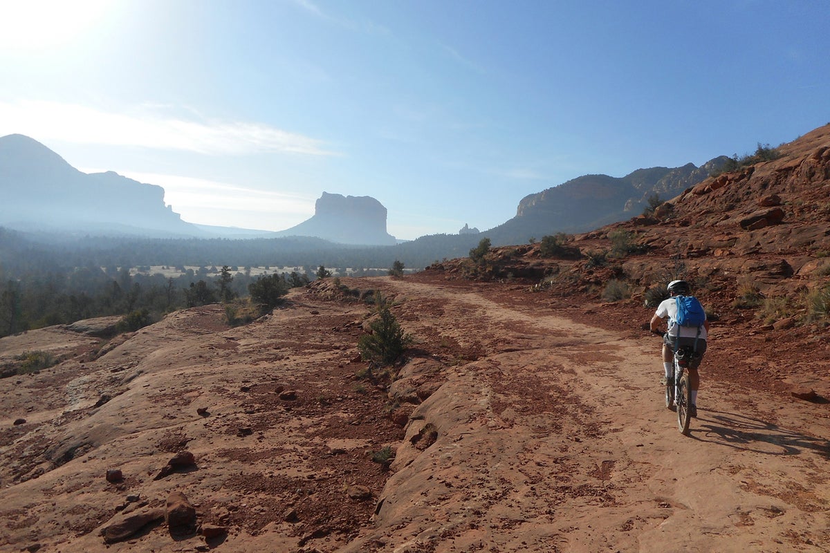 Person biking through desert landscape on a sunny day
