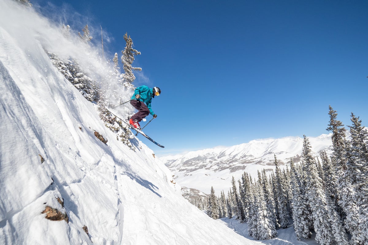 Person getting air on a steep at Crested Butte Ski Resort on a sunny day