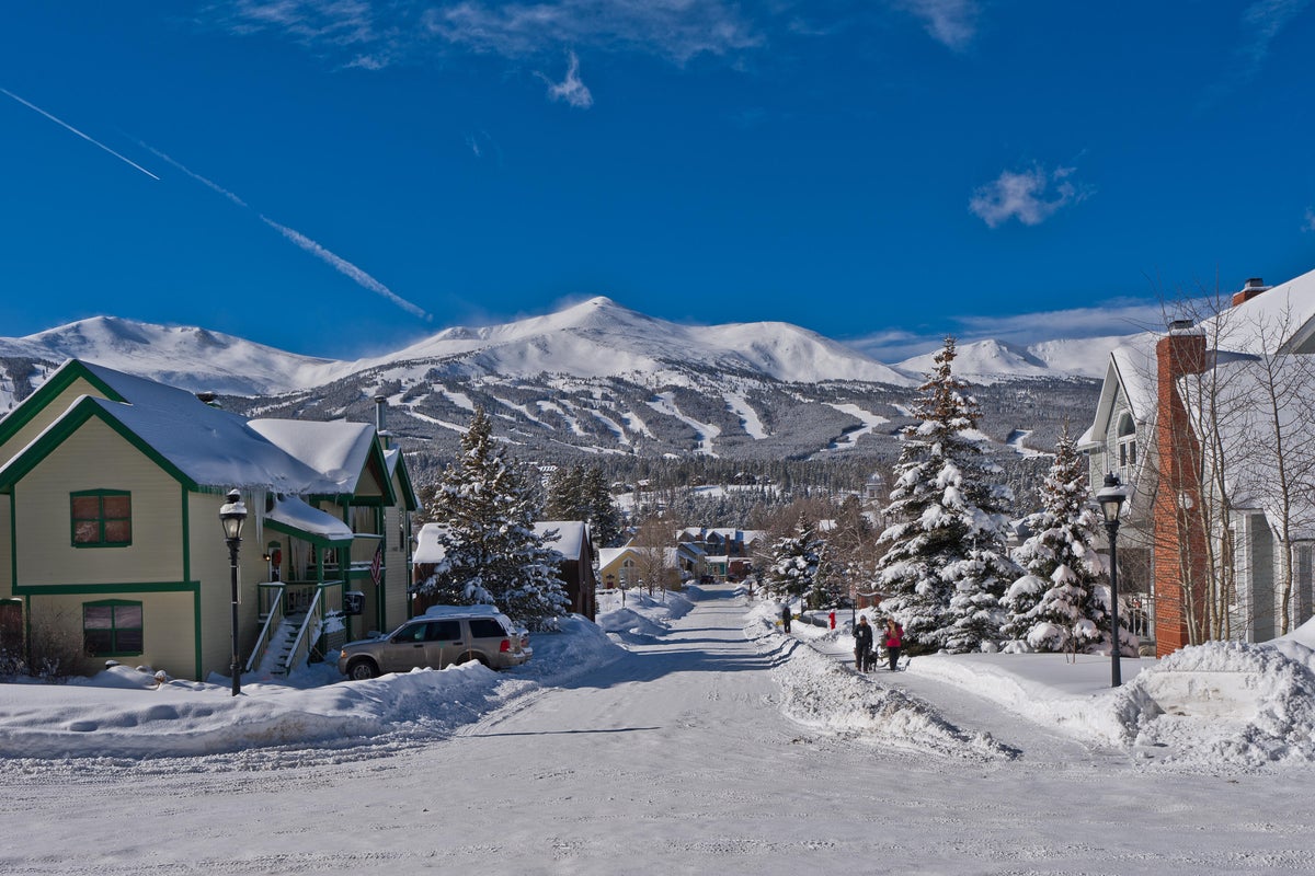 Snowy street in the town of Breckenridge, Colorado, with the ski resort in the background