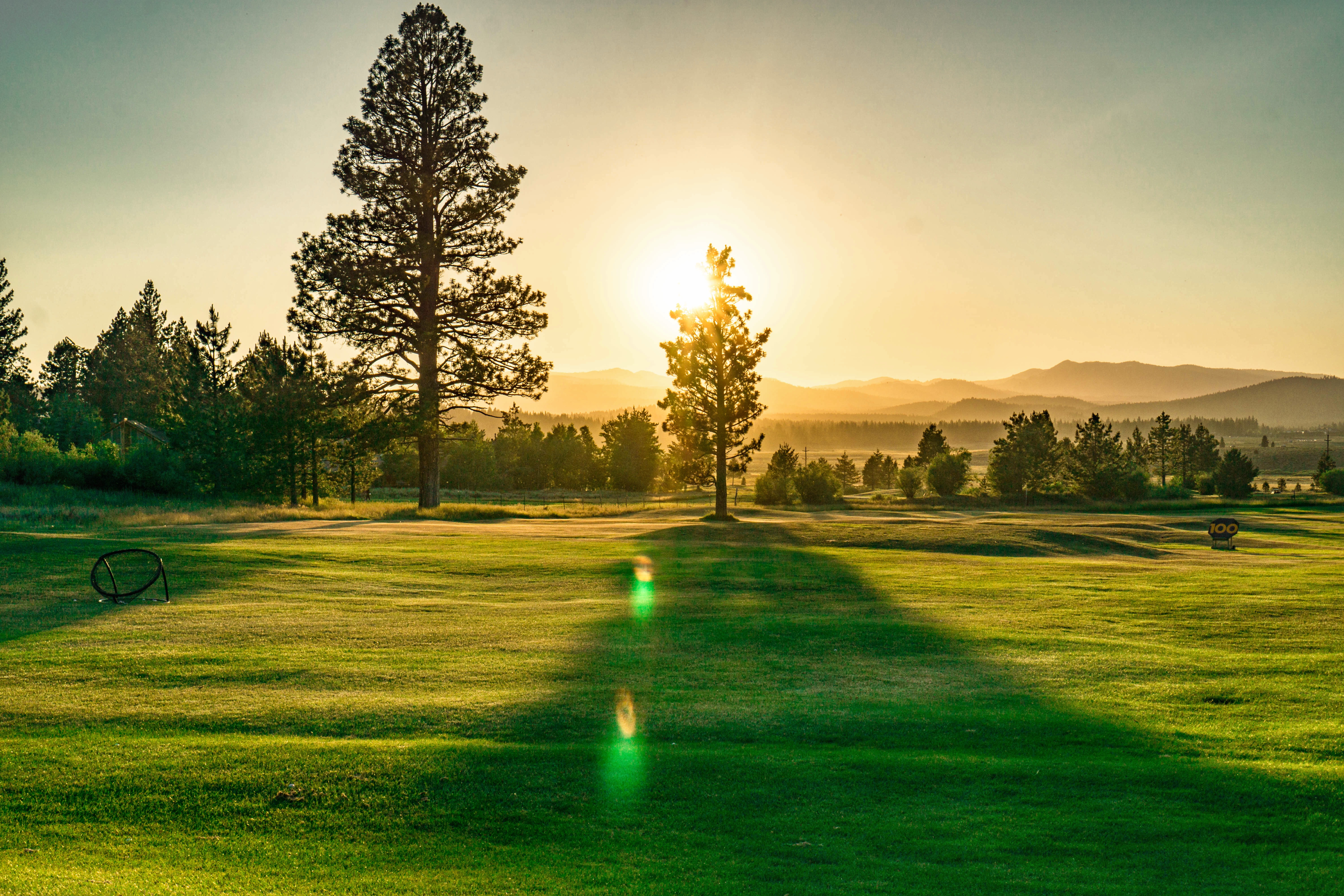 Sunset over mountains on a sunny day at Northstar California driving range