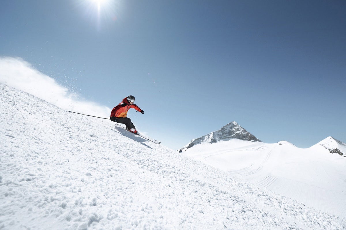 Skiing down Hintertux Glacier clopes on a warm clear day
