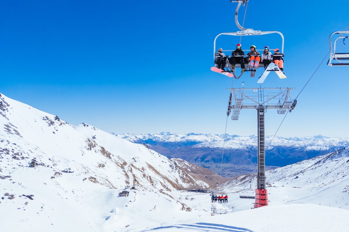 Group of skiers on chairlift on a sunny day