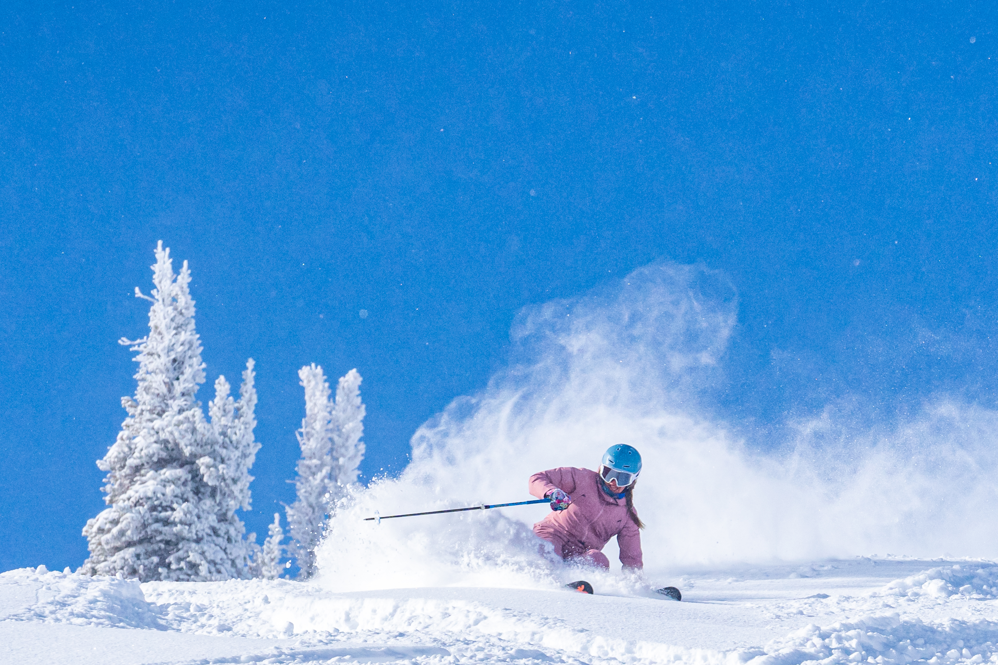 Female skier powder Aspen Snowmass.