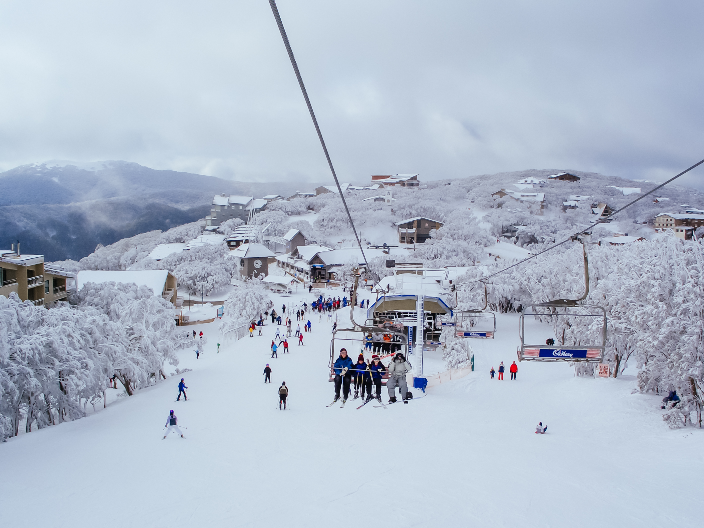 People riding chairlift at Mount Buller on a powder day