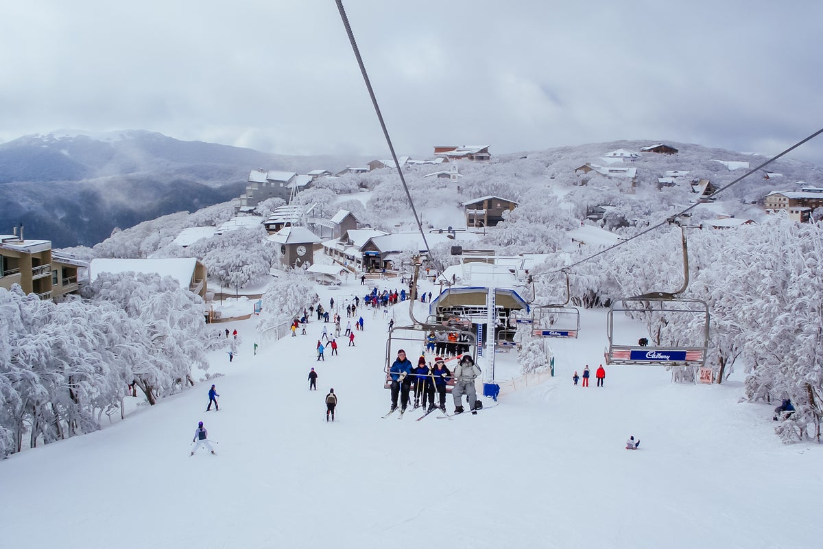 People riding chairlift at Mount Buller on a powder day