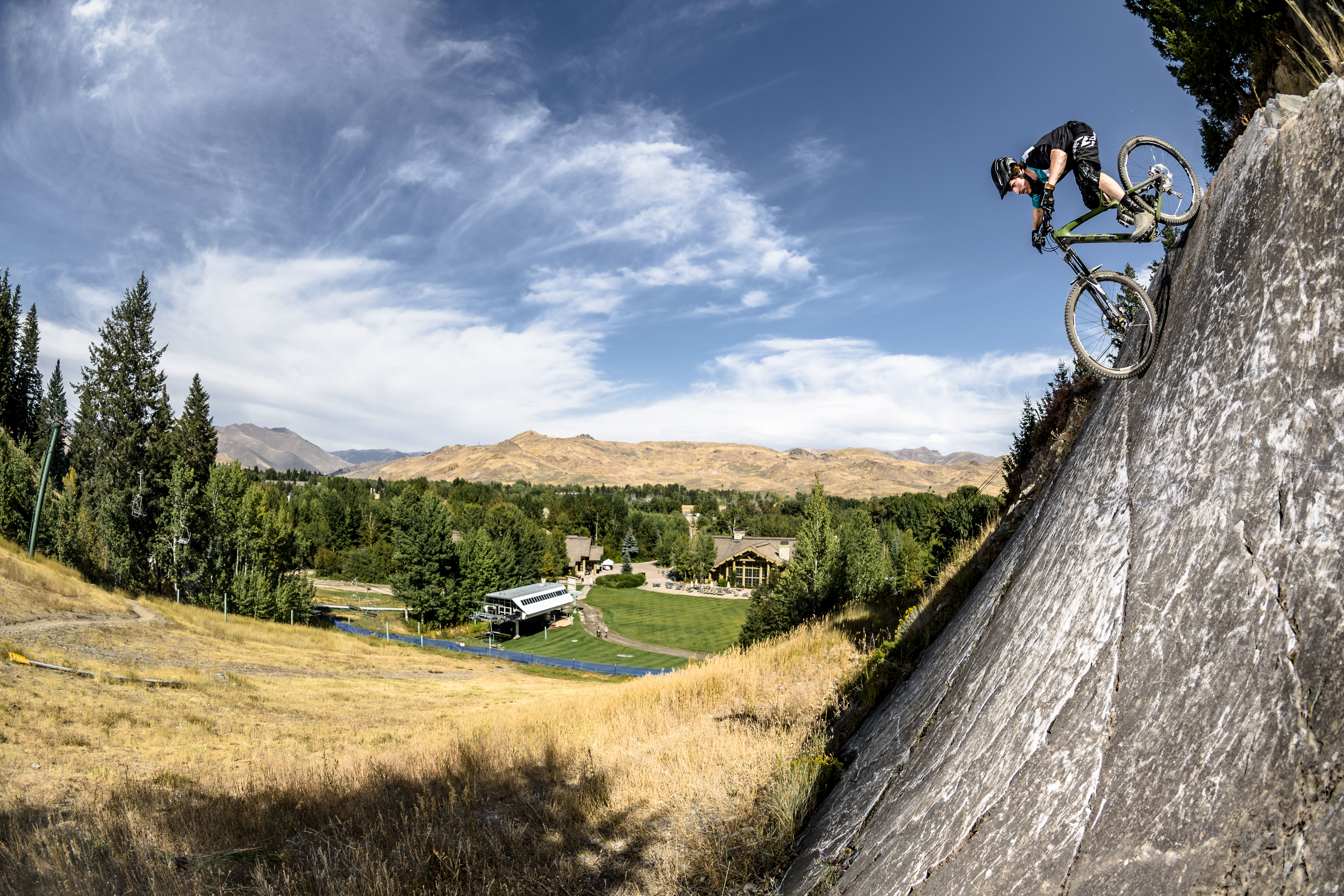 Biking down a steep rock face at Sun Valley Resort on a sunny summer day