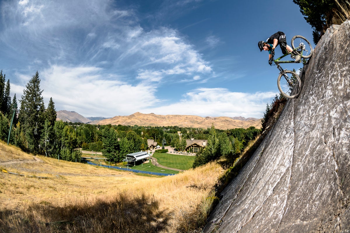 Biking down a steep rock face at Sun Valley Resort on a sunny summer day