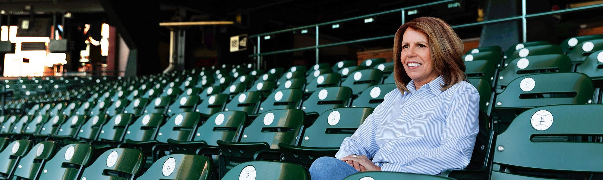 Woman sitting in stands of stadium