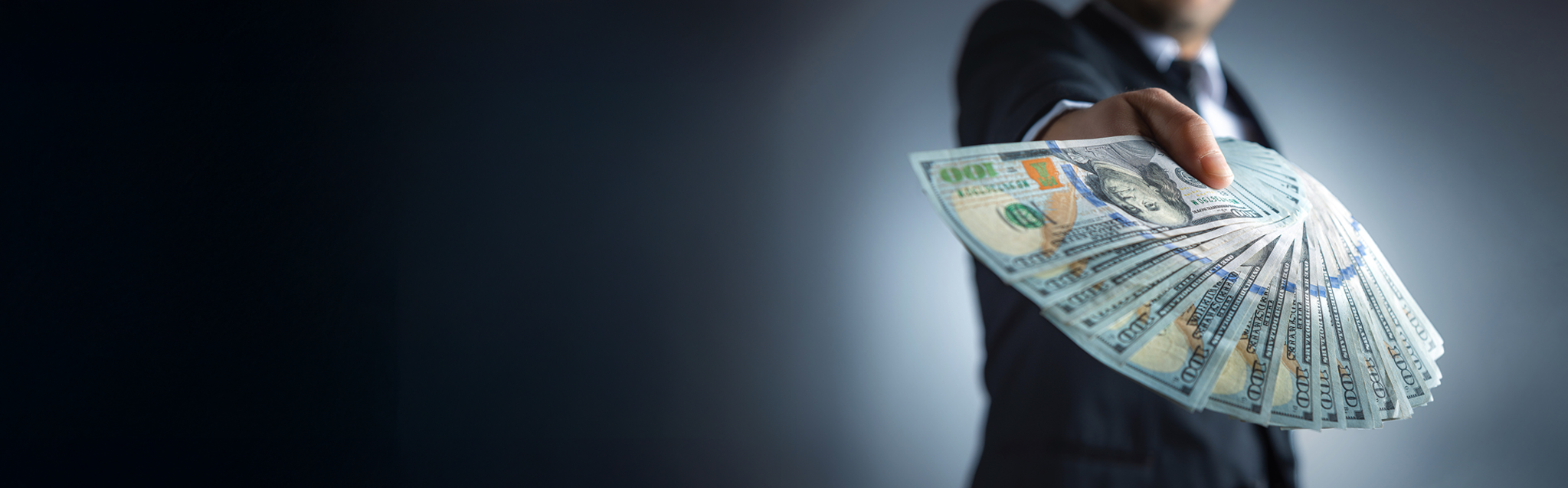 Person holding fanned out money.