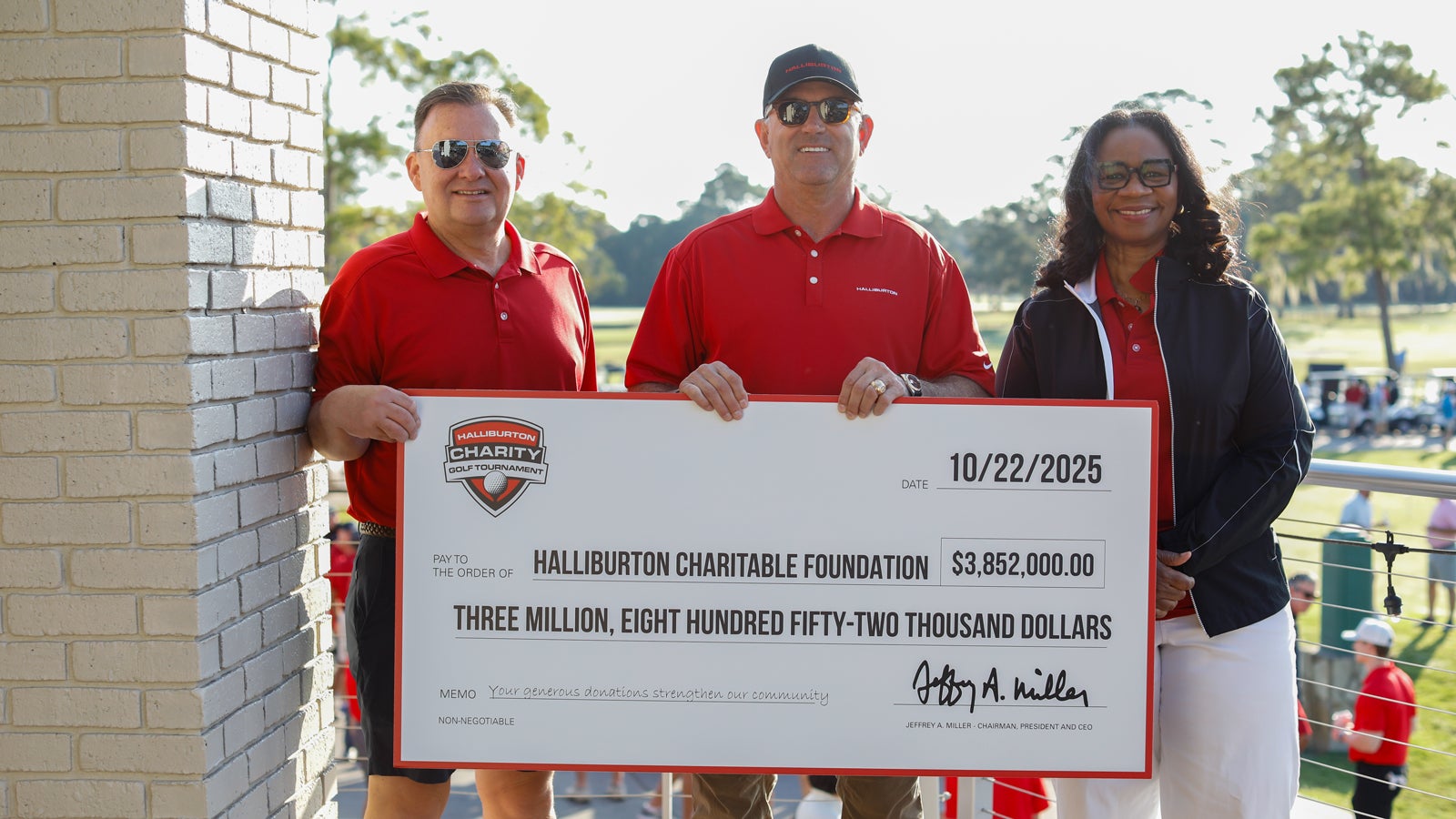 Jeff Miller and Halliburton executives holding the 2025 Halliburton Charity Golf Tournament charity check.