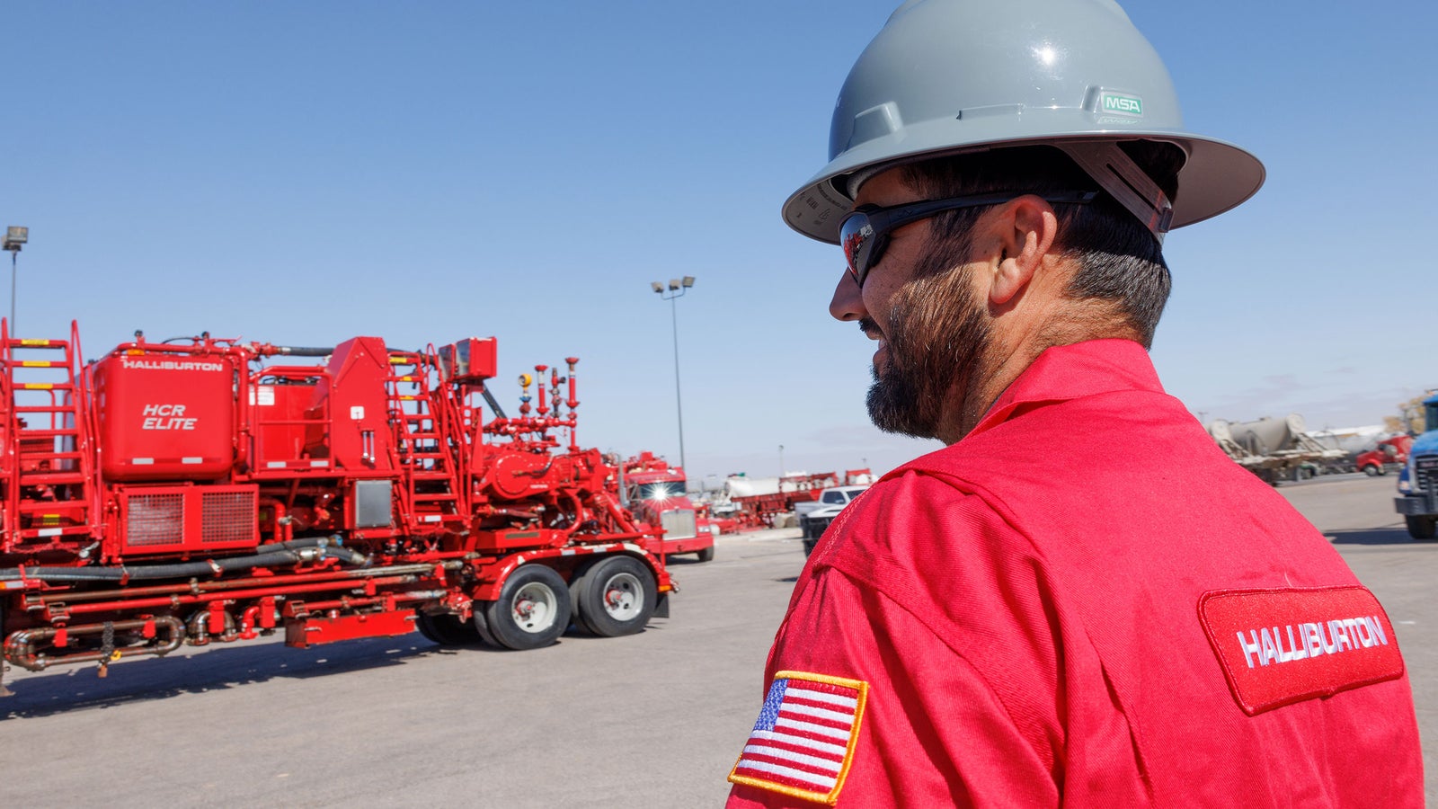Halliburton employee in red coveralls.