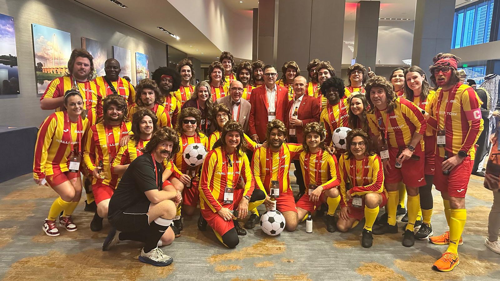 Group of employees wearing soccer jerseys.