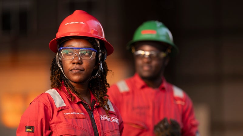 Halliburton employees wearing red coveralls.