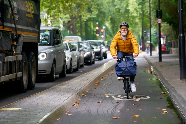 Man riding Brompton bike on cycle path
