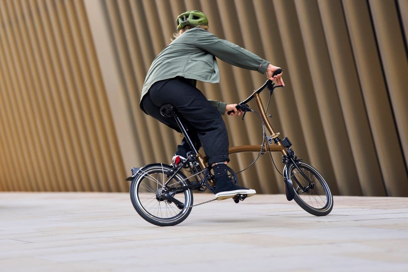 person riding a brompton electric p line bike