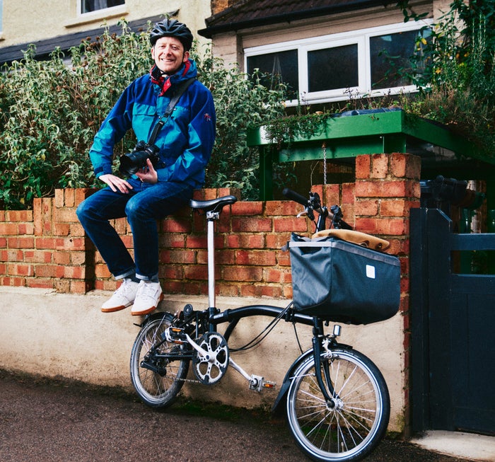 Man sat on wall with Brompton bike