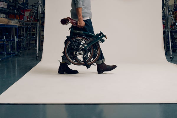 Person carrying Brompton x Bremont x Cheaney bike