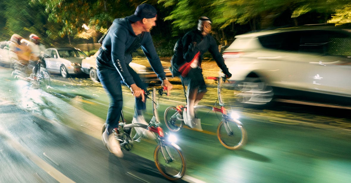 A fast motion image of two KnightRyders riding the Brompton x CHPT3 bikes