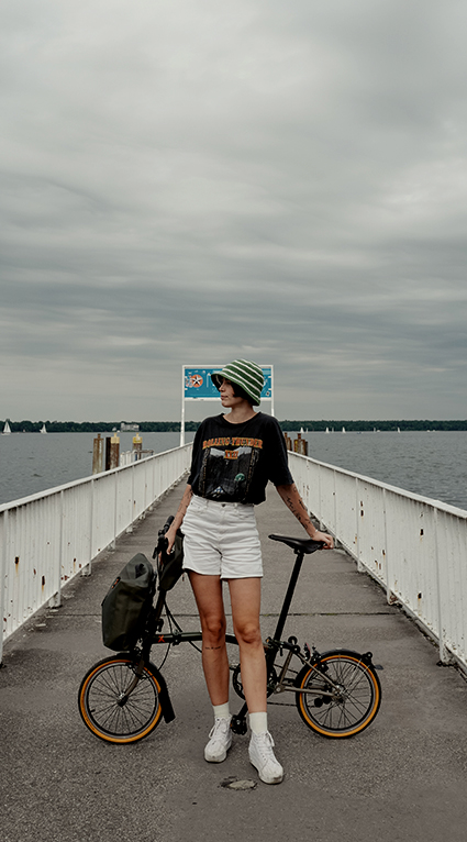 Content creator Lucy Bohr posing with her Brompton x Bear Grylls bike in Germany