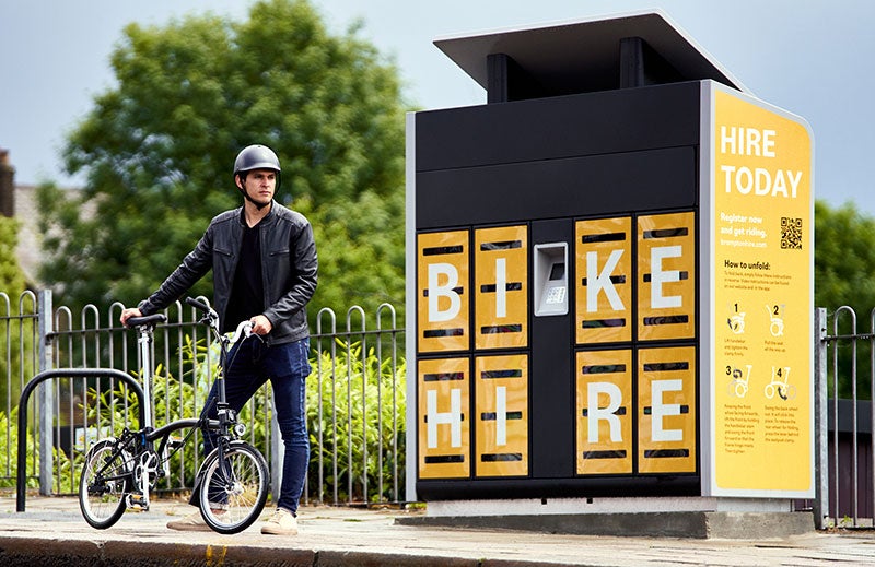People stood in an office with Brompton Bikes