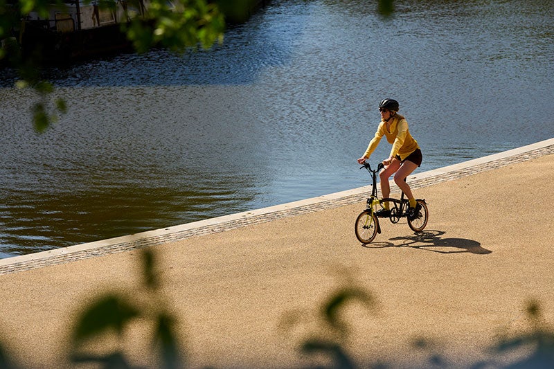 Person riding a Brompton x Tour de France bike
