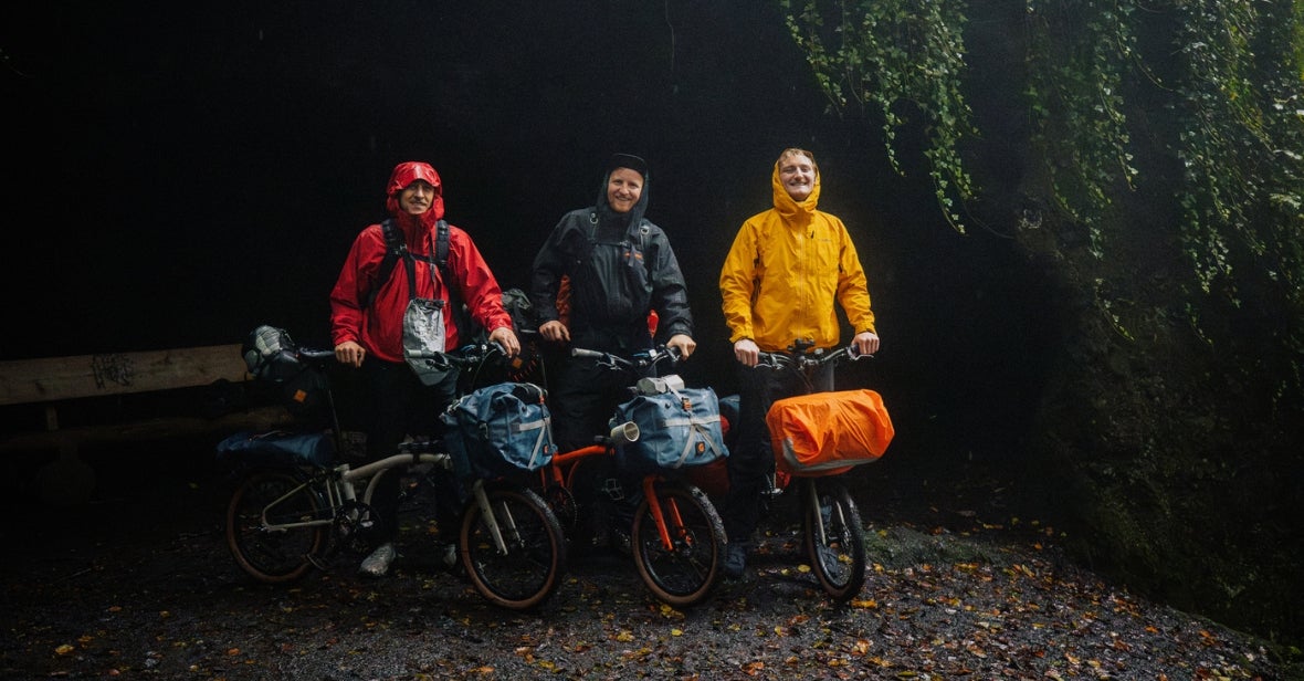 3 people in a line wearing waterproof coats