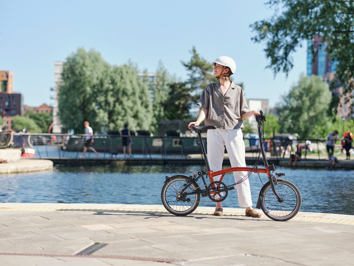 person riding a brompton bike in manchester