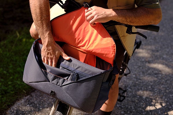 Close-up of person opening Brompton Electric G Line bag
