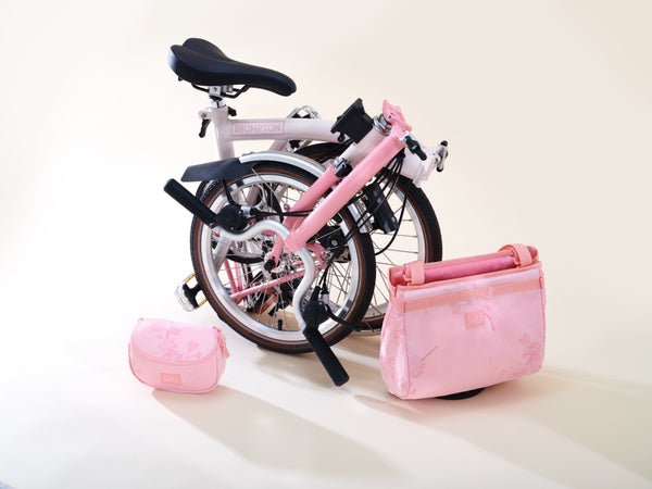 cherry blossom bike folded next to cherry blossom bag
