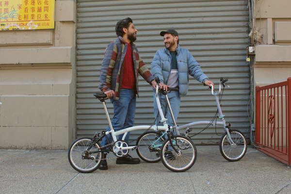 Two people stood with Brompton bikes
