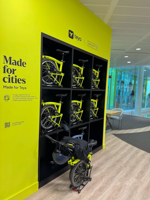 People stood in an office with Brompton Bikes