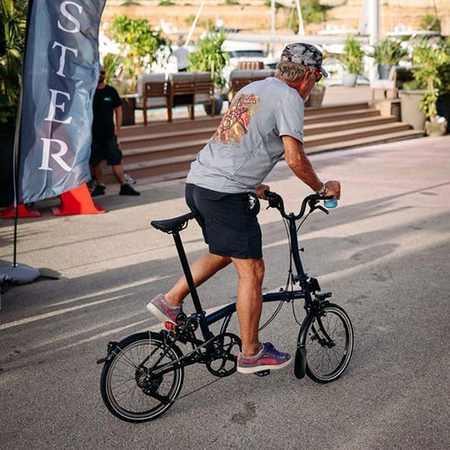 Person riding Brompton bike