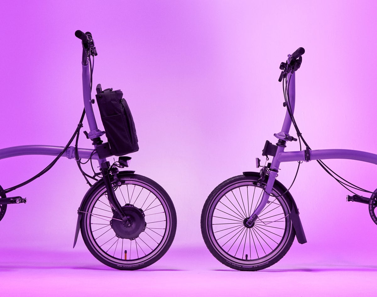 two brompton pop lilac bikes in front of a lilac background