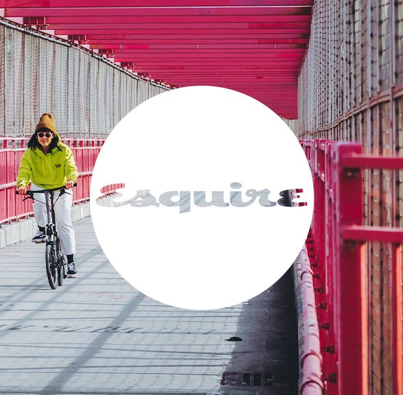 Esquire logo in white circle over Brompton bicycle