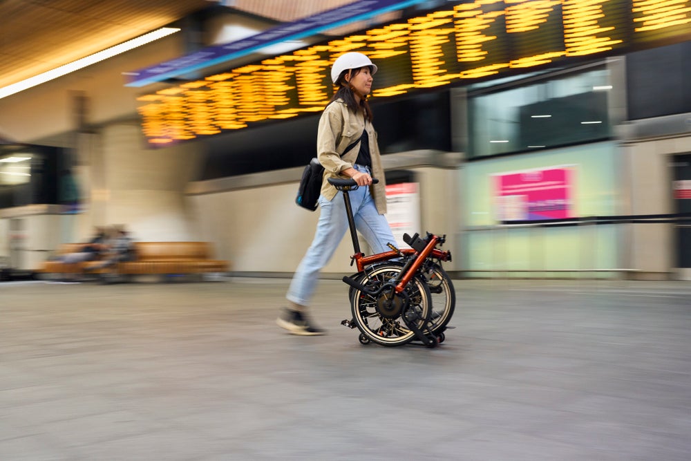 person rolling an brompton p line electric in flame lacquer