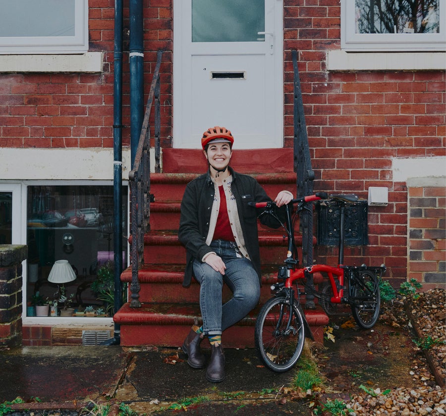 Vanessa standing outside her flat with her Brompton