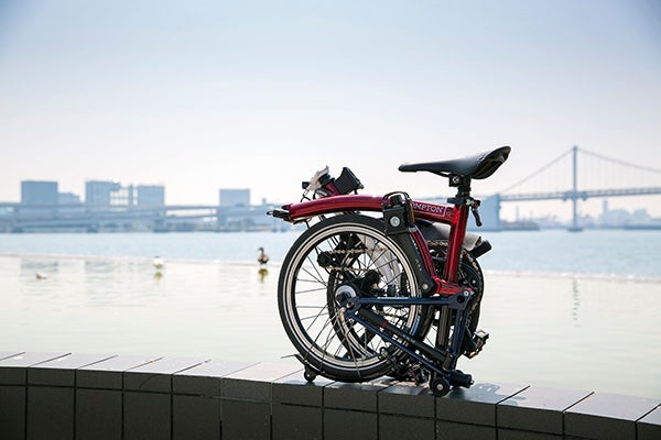 A folded Brompton x Team GB bike overlooking the river
