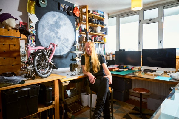 A photo of Graeme Raeburn in his studio in London with his Brompton Bicycle