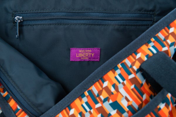 A close up image of a Brompton bag made with Liberty Fabric
