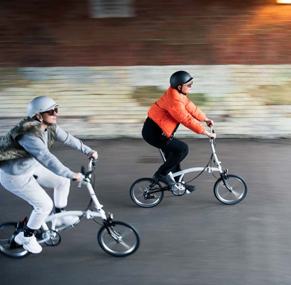 Two A Line Bromptons being ridden