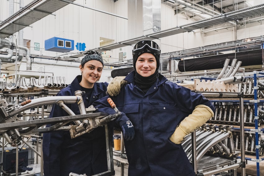 Two factory workers smiling in the Brompton factory