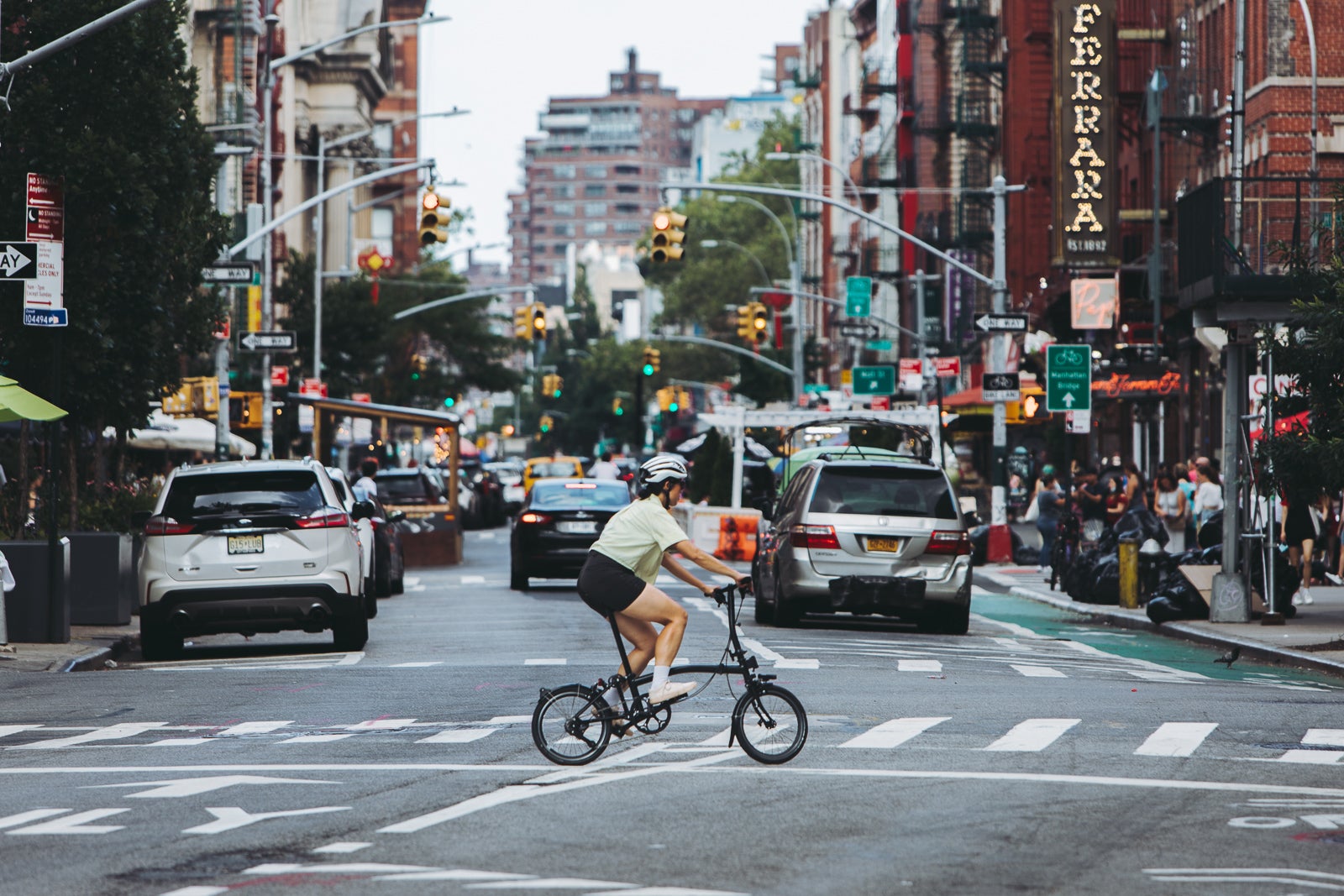 Image of person cycling Brompton bike across the road in New York City