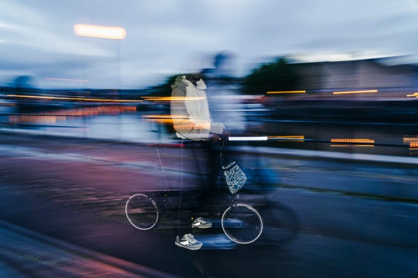 blurred image of someone riding brompton with bright nights collection