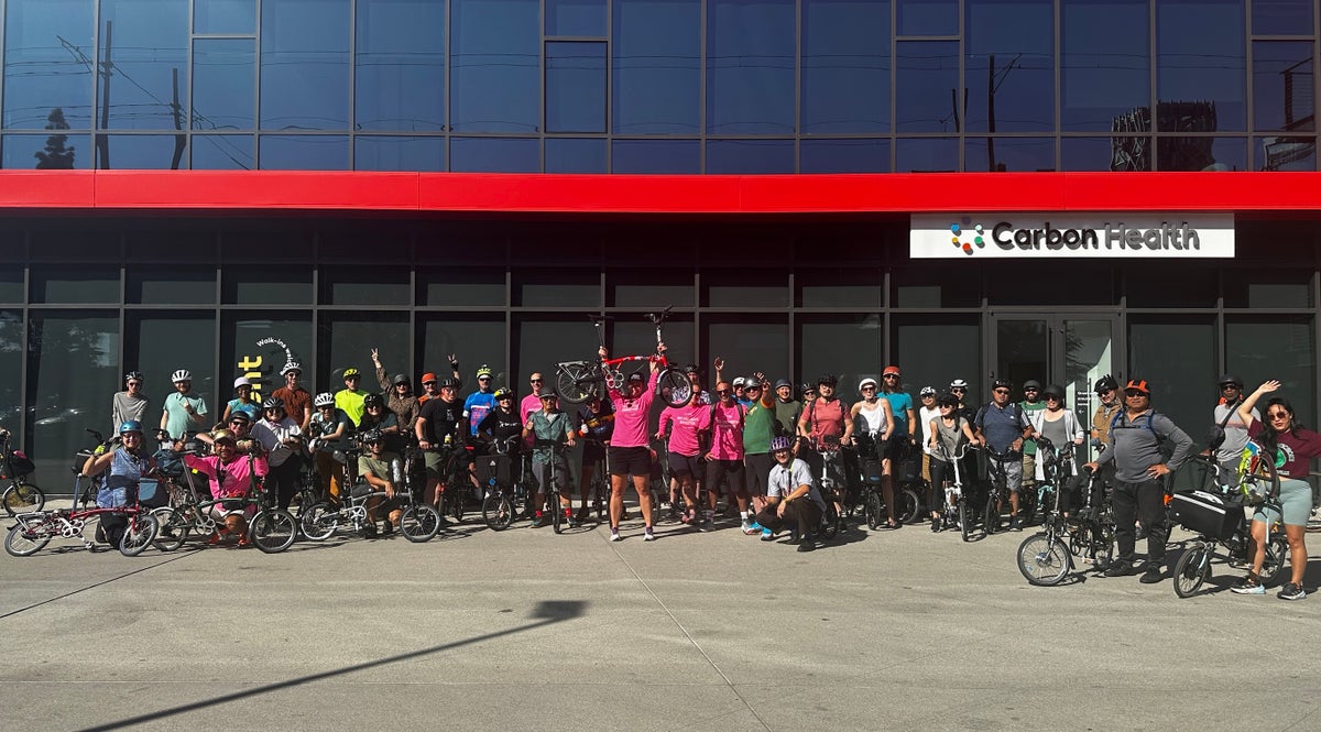 a group photo of a brompton ride in LA outside Carbon Health